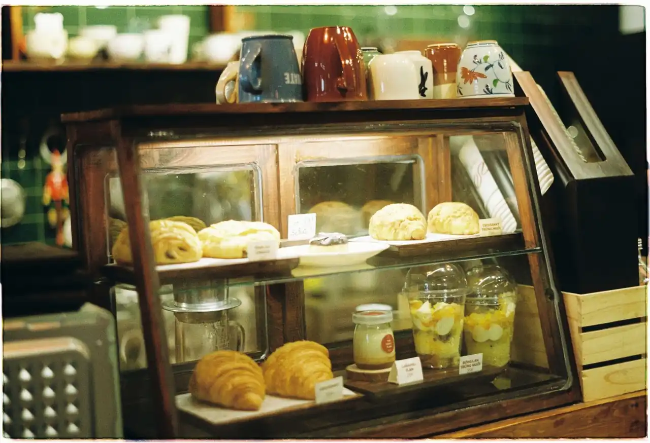 Refined patisserie cabinet display filled with handcrafted pastries and delicate desserts in Malvern