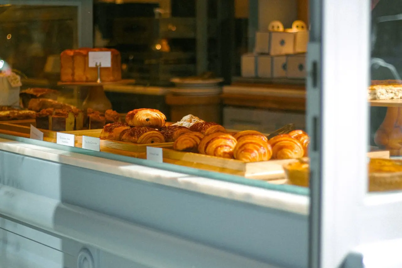Freshly prepared artisan croissants and pastries dusted with powdered sugar