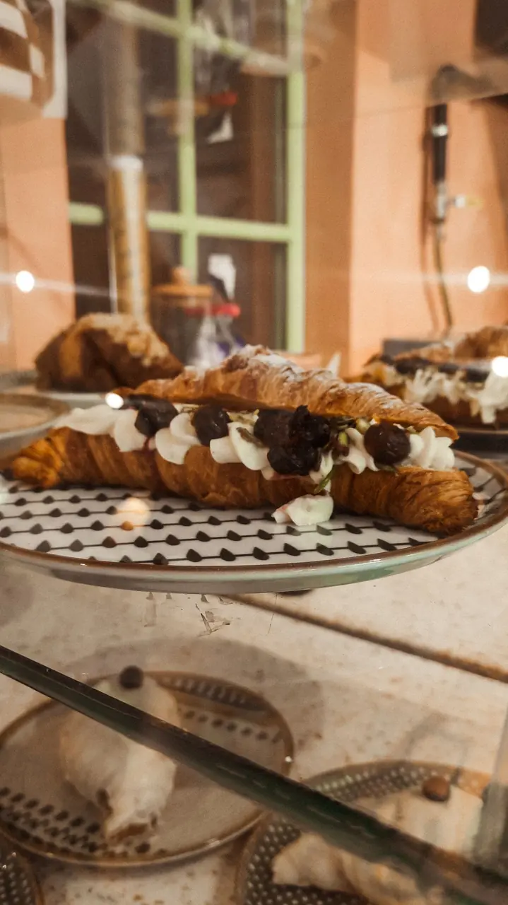 Detailed close-up of a filled pastry with chocolate and delicate cream