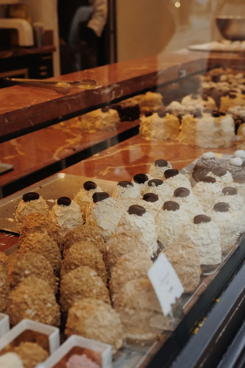 Freshly baked golden pastries displayed in an artisan pastry cabinet