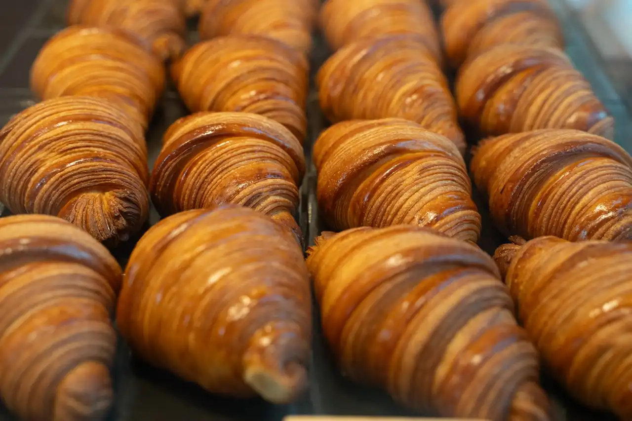 Flaky golden croissants baked fresh in bakery