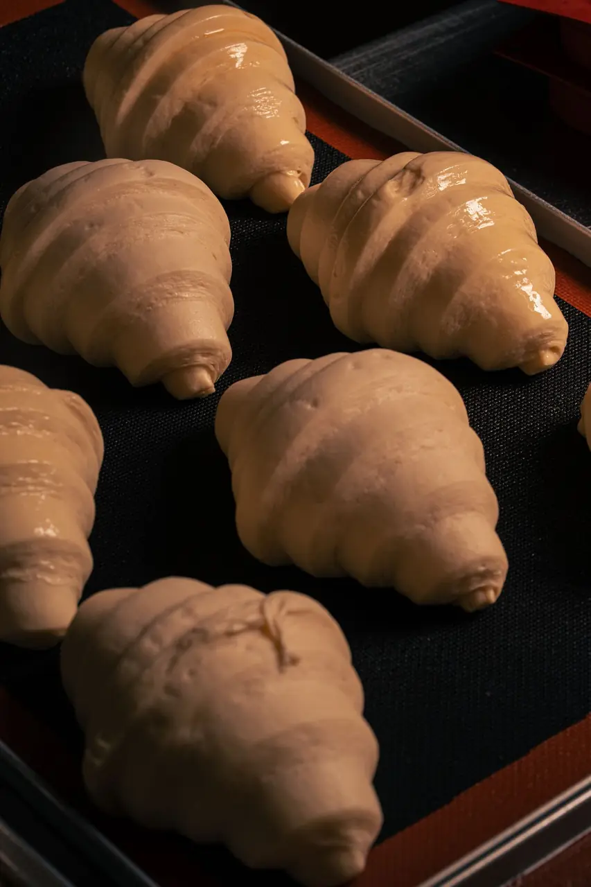 Layers of unbaked laminated croissant pastry prepared with cultured Australian butter